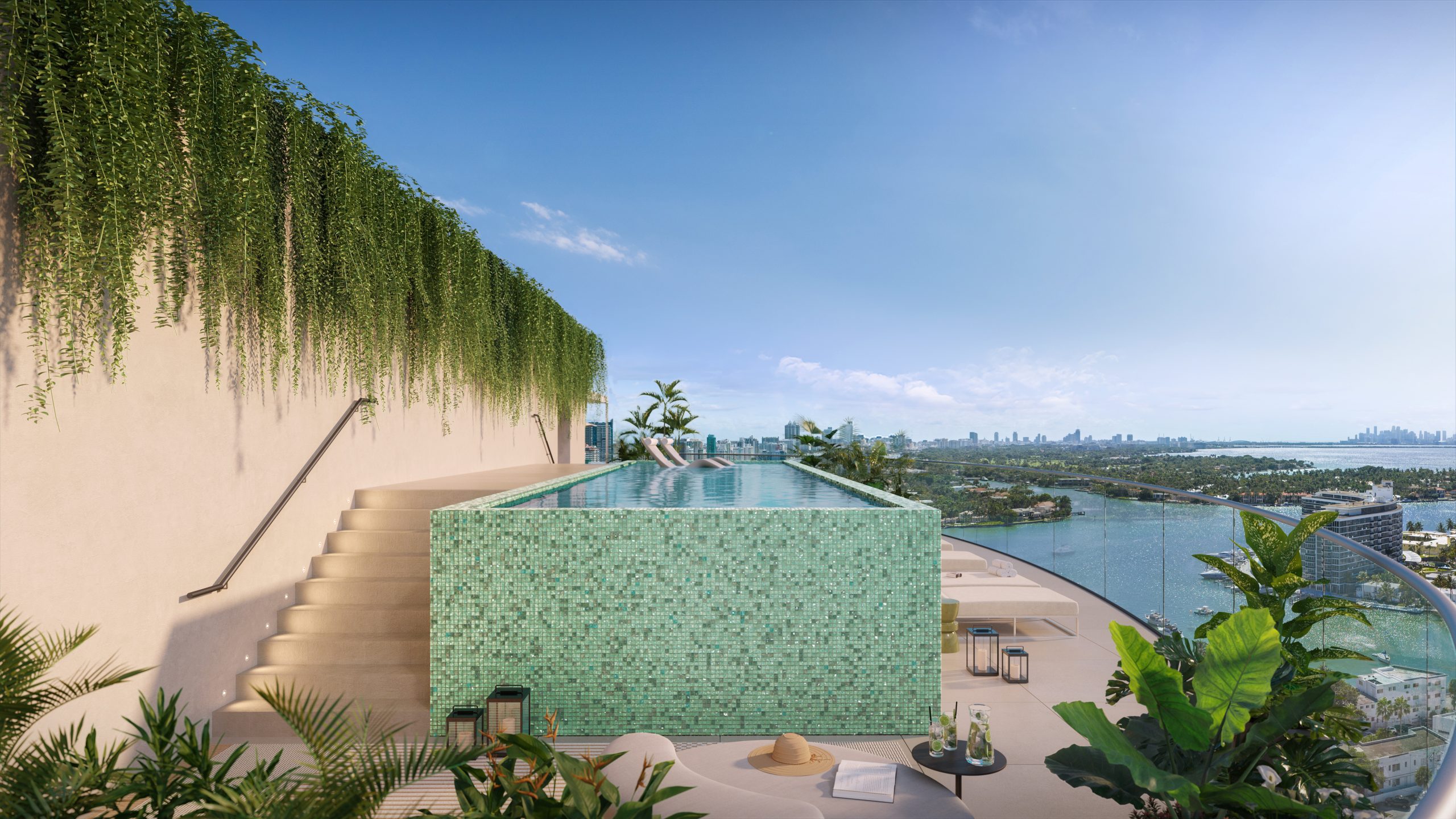 Rooftop infinity pool with green mosaic-tiled sun deck overlooking Biscayne Bay