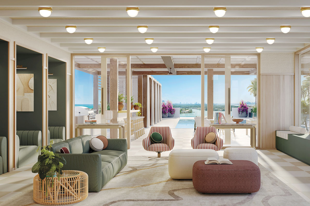 Indoor-outdoor lounge with green sofa and striped armchairs opening onto the pool deck and bay view