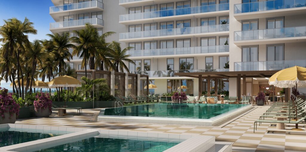 PALMA Miami Beach pool deck with yellow umbrellas and lounge chairs against the tower facade