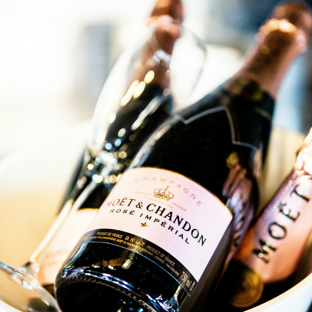 Moët & Chandon champagne bottles, sitting alongside a champagne glass